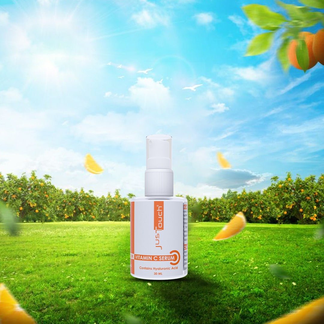 Vitamin C serum bottle with a scenic background of green grass and orange trees.