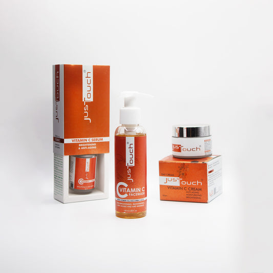 Just Touch Vitamin C skincare products including cream, serum, facial cleanser, and packaging